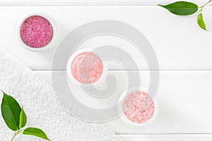 Rose cosmetic set for body care on white wooden background