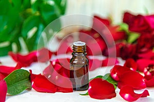 Rose essential oil in a small bottle. Selective focus.