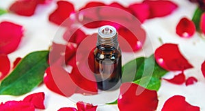 Rose essential oil in a small bottle. Selective focus.