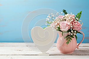 Rose flower bouquet in pink vase and heart shape sign