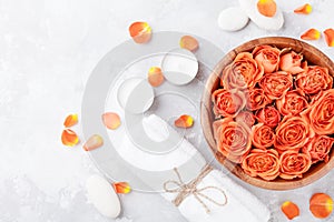 Rose flower in bowl, towel and candles on stone table top view. Spa, aromatherapy, wellness, beauty background.