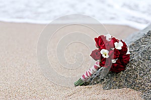 Rose flower wedding bouquet on beach