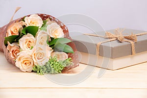 Rose flower on wooden table with gift box and copy space