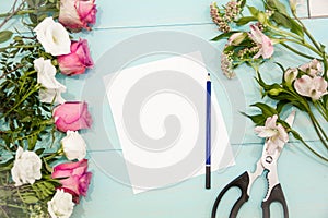 Rose flowers branch was lying on the table top to be cut with scissors, ready to make a bouquet, floral concept, preparing for the