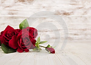 Rose flowers, red on wooden grunge background, floral card