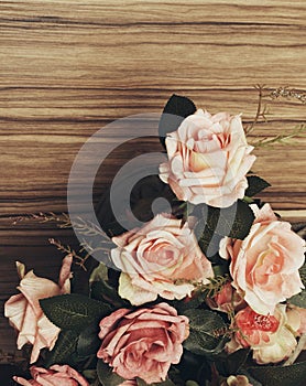 Rose flowers on wooden background. Retro views