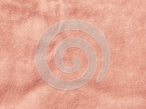 Rose gold color velvet fabric texture top view. Female blog pink velour background. Smooth soft velvety cloth metallic