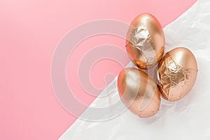 Rose gold eggs on crumpled paper create a chic look against a white and pink background, Ai Generated