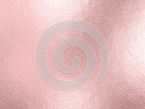 Rose gold foil background with light reflections photo