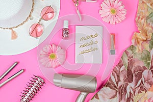 Rose gold hair care accessories and make up on a pink background