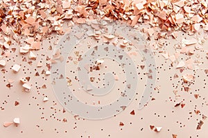 Rose golden confetti scattered on blush pink background. Generative AI