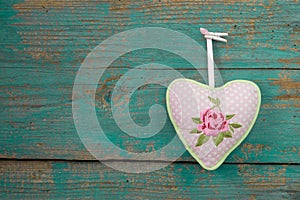 Rose heart with dots and turquoise wood for a background of a gr