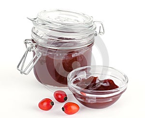 Rose hip jam and fruits over white photo