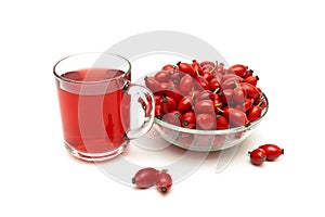 Rose hips and a drink on a white background