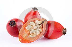 Rose hips with fruit cross-section over white photo