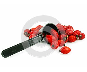 Rose hips and measuring spoon