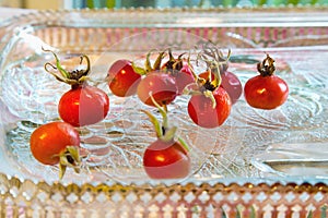 Rose hips from Rosa rugosa on a glass plate