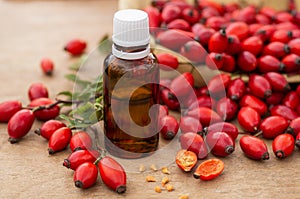 Rose-hips and rose hip seed oil on the wooden table. Rose hip  commonly known as rose hip Rosa canina.