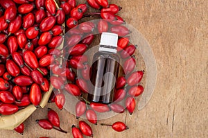 Rose-hips and rose hip seed oil on the wooden table. Rose hip  commonly known as rose hip Rosa canina.