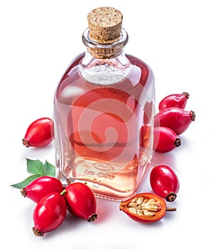 Rose-hips and rosehip seed oil on the white background