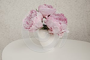 Rose peonies on a white table