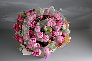 Rose peony Misty Bubbles. Bouquet flowers of pink roses in glass vase on dark grey rustic wooden background. Shabby chic