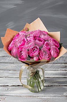 Rose peony Misty Bubbles. Bouquet flowers of pink roses in glass vase on dark grey rustic wooden background. Shabby chic