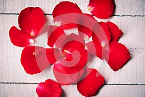 Rose petals on wooden background , tone vintage style classic / flower red rose petals for valentine day