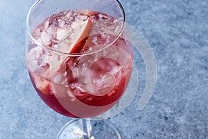 Rose Pink Blush Wine Cocktail with Pomegranate Seeds, Apple Slice and Crushed Ice.