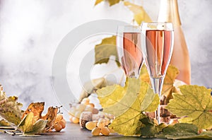 Rose pink champagne glasses and bottle, gray background, wine tasting concept, copy space