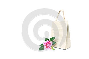 Rose pink flower with paper shopping bag isolated on the white b