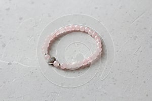 Rose quartz bracelet. A bracelet made of stones on a hand from natural stone Pink rose quartz. Bracelet made of natural stones.