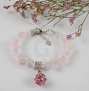 Rose quartz bracelet on white background