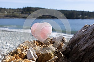 Rose Quartz Crystal Heart and Ocean Background