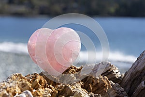 Rose Quartz Crystal Heart and Ocean Background