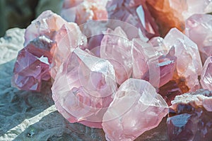 rose quartz crystals close up in daylight. pink healing mineral geode texture, esoteric concept, spiritual healing