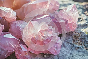 rose quartz crystals close up in daylight. pink healing mineral geode texture, esoteric concept, witchcraft gem for