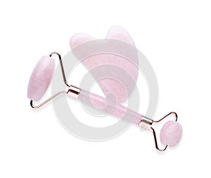 Rose quartz gua sha tool and facial roller isolated on white, top view