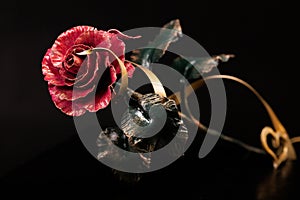 Rose with a red bloom made of metal with gold tape and heart