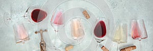 Rose, red, and white wine, with corscrews and corks, shot from above