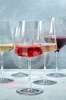 Rose, red and white wine in elegant modern glasses at a wine tasting at a winery