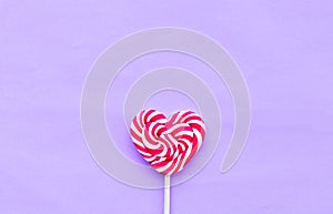 Rose valentine day hearth shape lollipop on the violet background