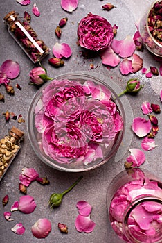 rose water in a glass bowl with petals and fresh flowers