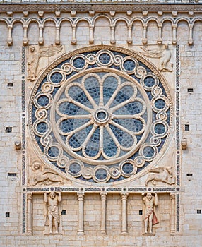 Rose window from the facade of the Duomo of Spoleto. Umbria, central Italy.