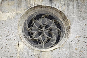 Rose window on the wall of Parochial Church in Fiera di Primiero.