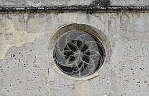 Rose window on the wall of Parochial Church in Fiera di Primiero.