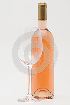 Rose wine bottle with empty glass