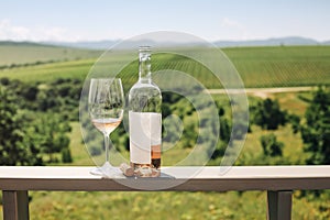 Rose wine bottle, grape vine, glass and cork