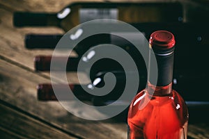 Rose wine bottle on wooden background