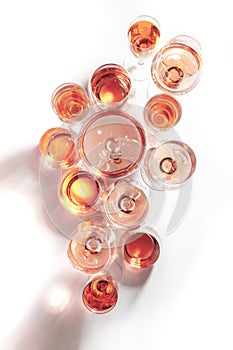 Rose wine of different shades in glasses on white background. Rosado, rosato or blush wines tasting photo